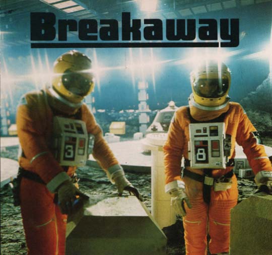 Caption: Breakaway, Image: 2 Space-Suited Figures at Waste Storage Area