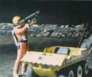 Spacesuited Figure Holding Laser Weapon, Standing Next to Moonbuggy